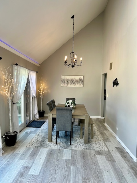 6414 Suttondale Road Huntley, IL 60142 - Photo 5 of 24 a view of a dining room with furniture and wooden floor