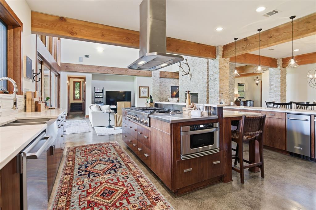 1138 Bancroft Road Keller, TX 76248 - Photo 14 of 39 Gourmet kitchen with a large central island, stainless steel appliances, and wood-finish cabinetry
