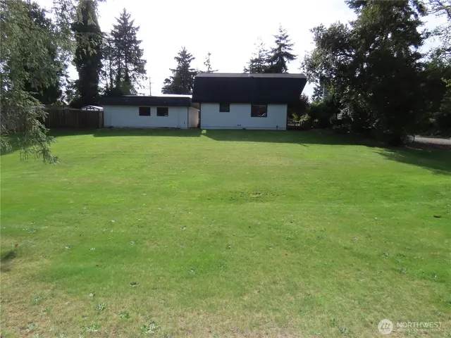 a view of a house with a yard porch and sitting area