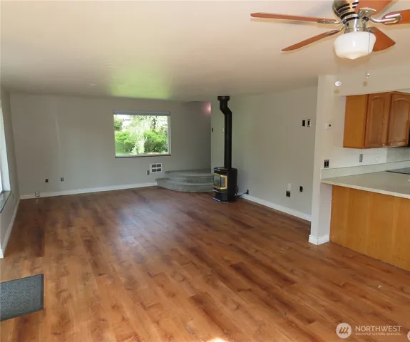 wooden floor in an empty room with a window