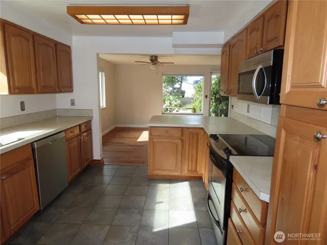 a kitchen with a sink a stove top oven and cabinets