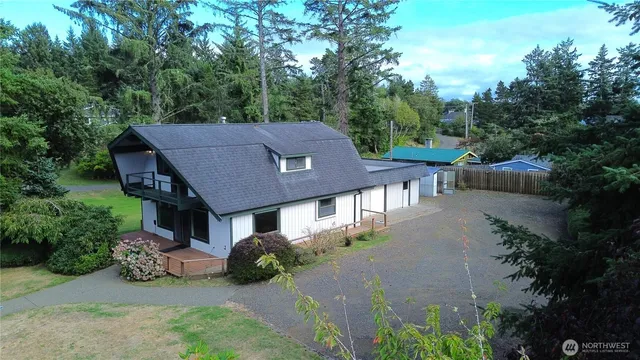 an aerial view of a house a yard and lake view