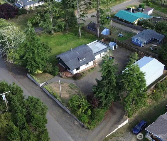 an aerial view of a house with a yard