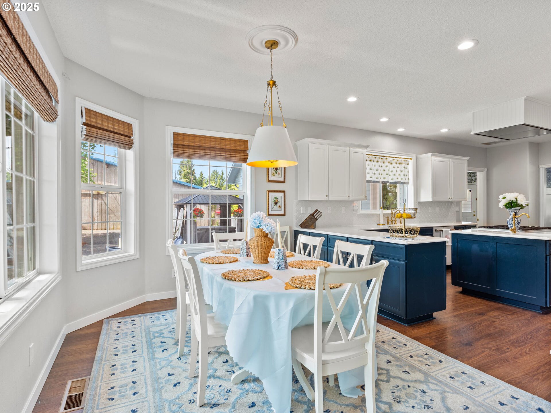 23751 Schultz Road Northeast Aurora, OR 97002 - Photo 15 of 48 a open dining room with stainless steel appliances kitchen island granite countertop a dining table chairs and a refrigerator