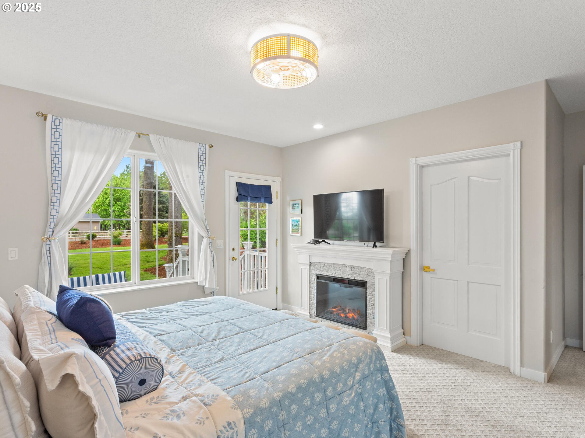 23751 Schultz Road Northeast Aurora, OR 97002 - Photo 19 of 48 a bedroom with a bed and a flat screen tv