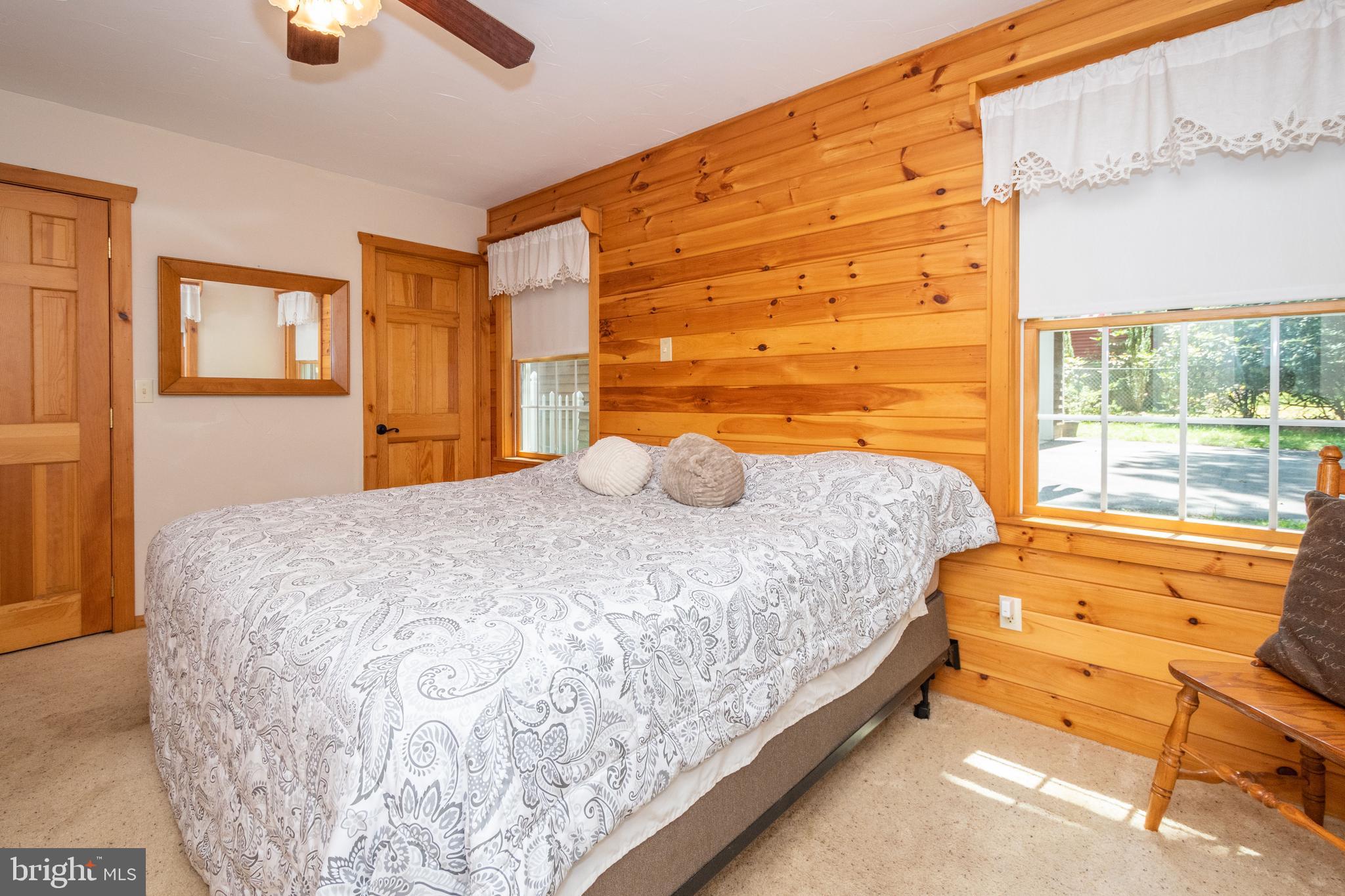 302 Oak Way Road Swanton, MD 21561 - Photo 25 of 56 a bedroom with a bed and lamp next to window