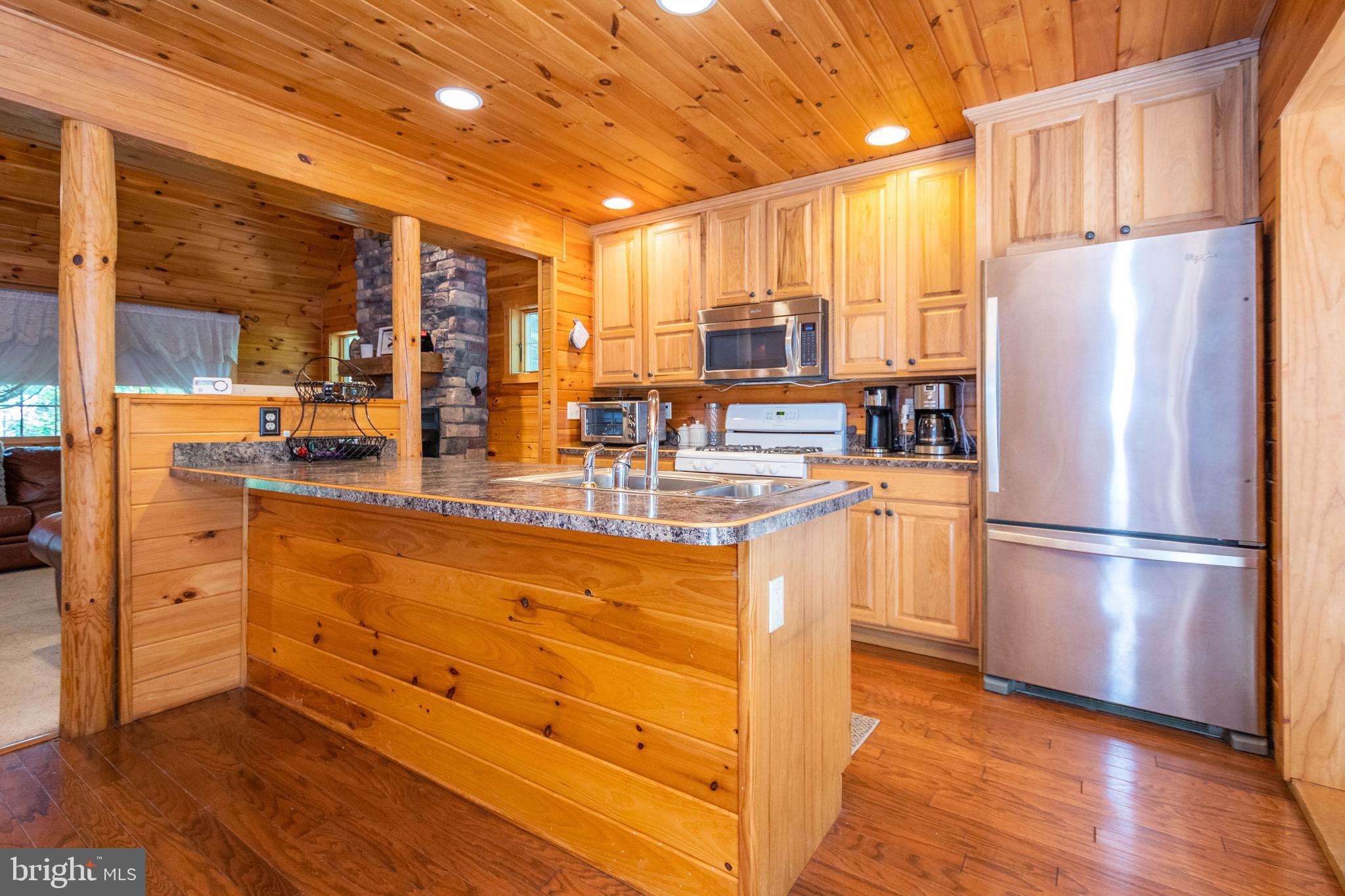 302 Oak Way Road Swanton, MD 21561 - Photo 8 of 56 a kitchen with refrigerator and cabinets