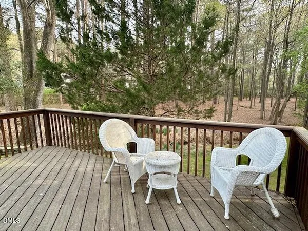 a view of a deck with table and chairs and wooden floor