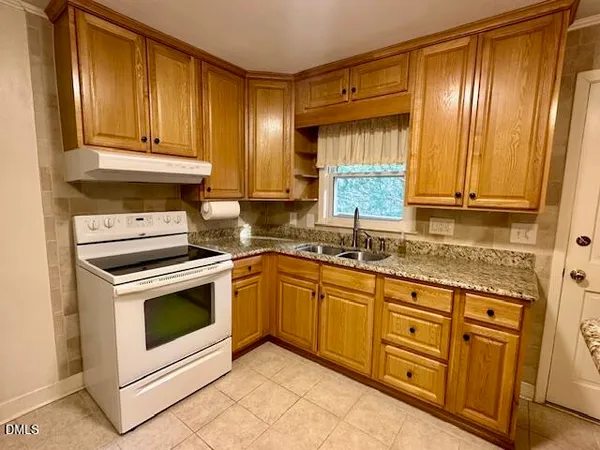 a kitchen with granite countertop cabinets stainless steel appliances and a sink