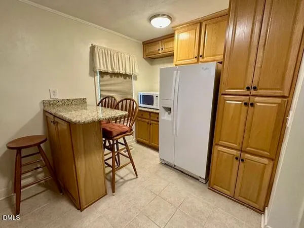 a kitchen with stainless steel appliances granite countertop cabinets and a refrigerator