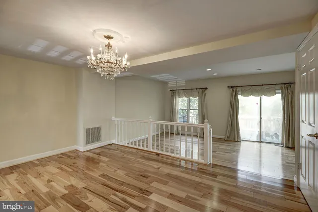 wooden floor in an empty room with a mirror