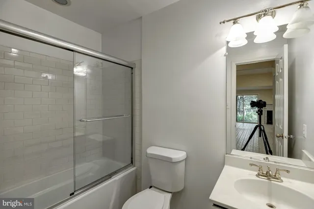 a view of an empty room with a fireplace and a window