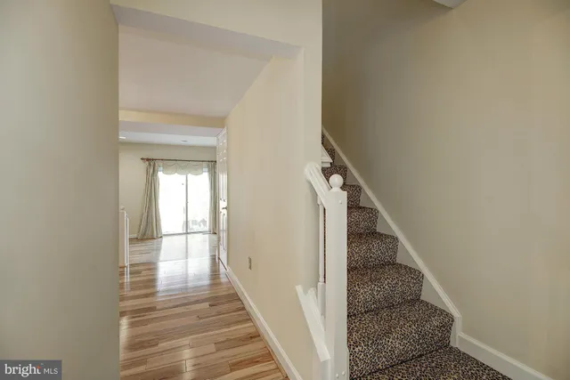 a view of a hallway view with wooden floor and staircase