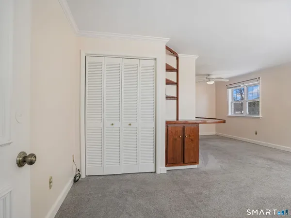 an empty room with windows and closet