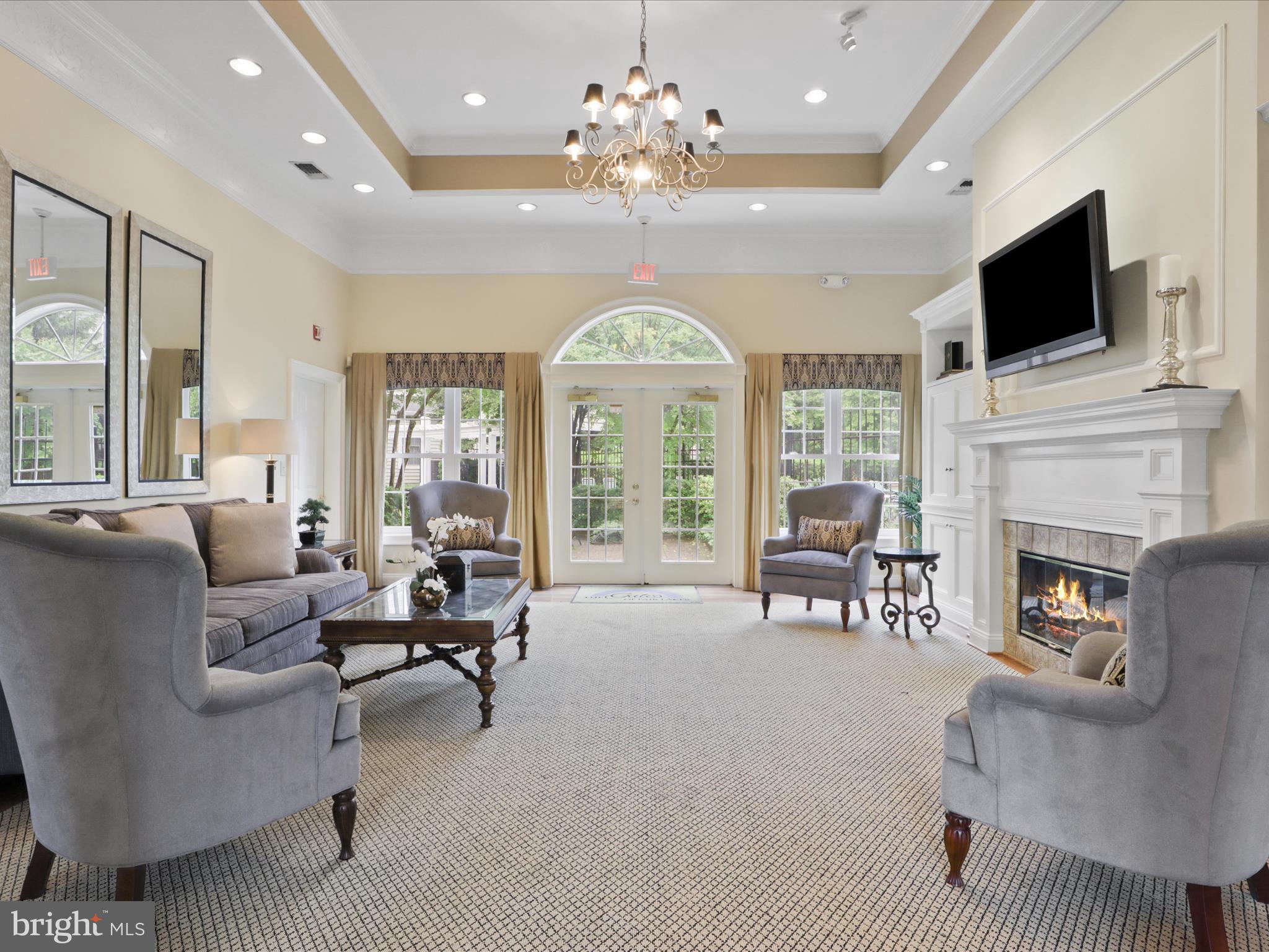 4574 Superior Square Fairfax, VA 22033 - Photo 25 of 44 a living room with furniture a fireplace and a flat screen tv