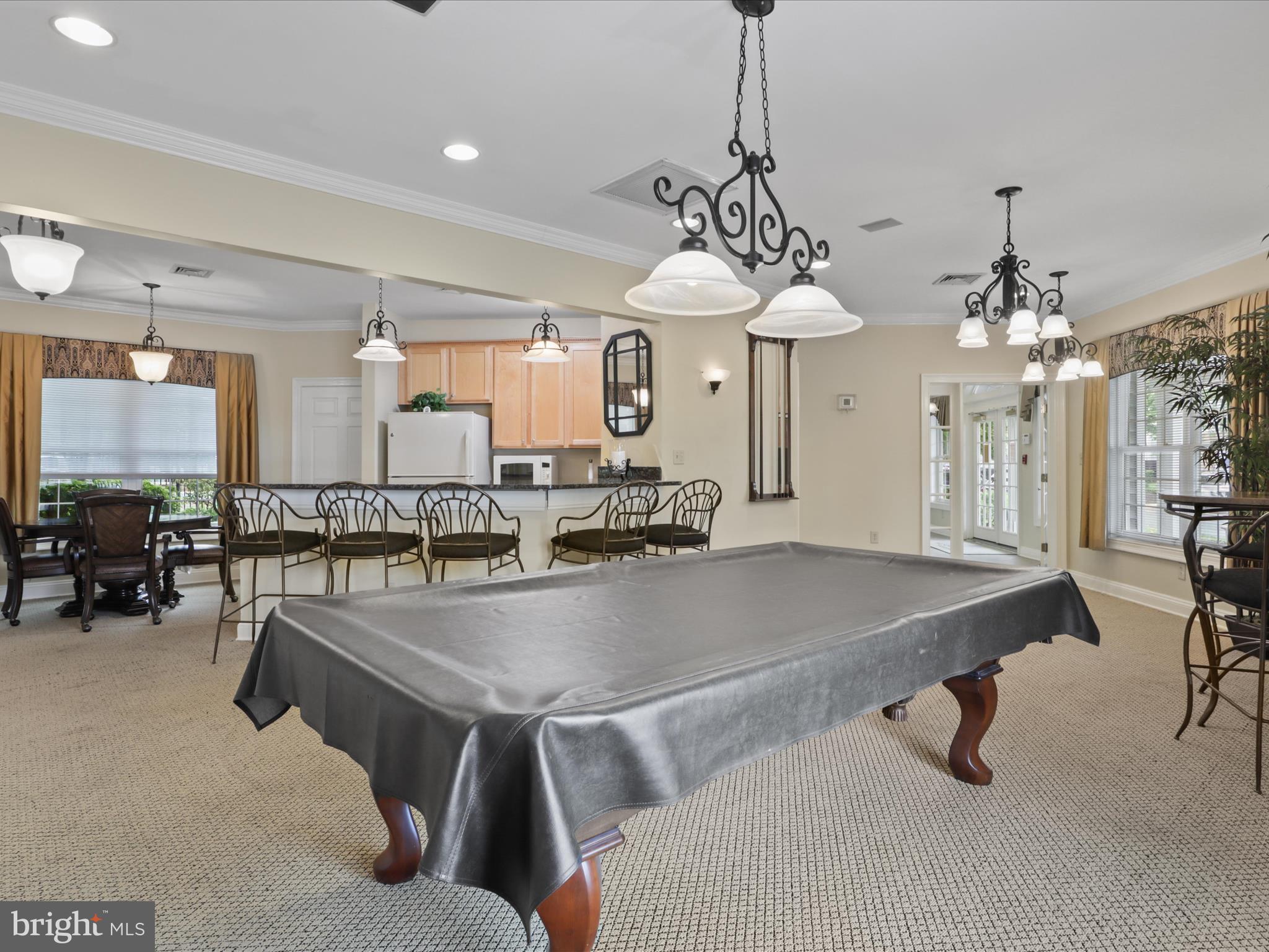 4574 Superior Square Fairfax, VA 22033 - Photo 26 of 44 a room with lots of tables a chandelier and couches