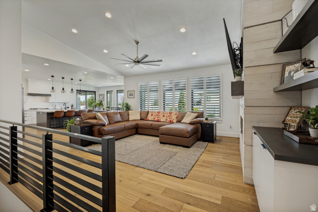 13257 Sky Rnch Road Herriman, UT 84096 - Photo 3 of 17 Vaulted ceiling with recessed lighting, wood-finish flooring, plantation shutters, and a built-in media cabinet with floating shelves
