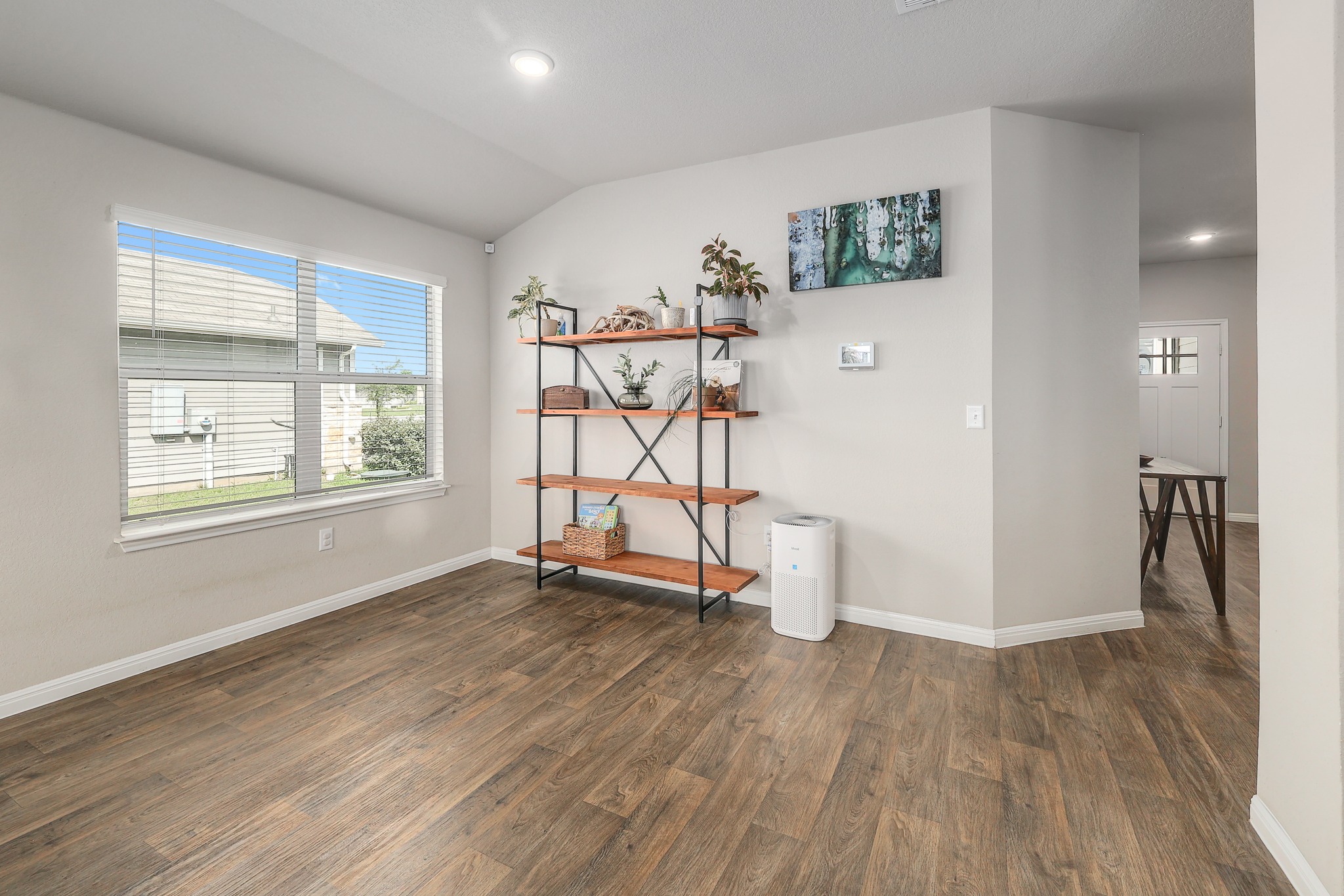 413 Hunter Loop Bertram, TX 78605 - Photo 6 of 27 A naturally illuminated living area featuring high ceilings, large window creating a cozy breakfast area