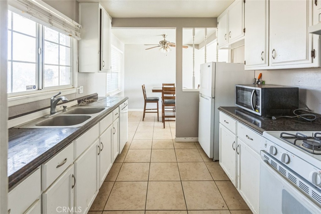 15917 Lee Street Mojave, CA 93501 - Photo 13 of 34 a kitchen with granite countertop a sink appliances cabinets and a counter top space
