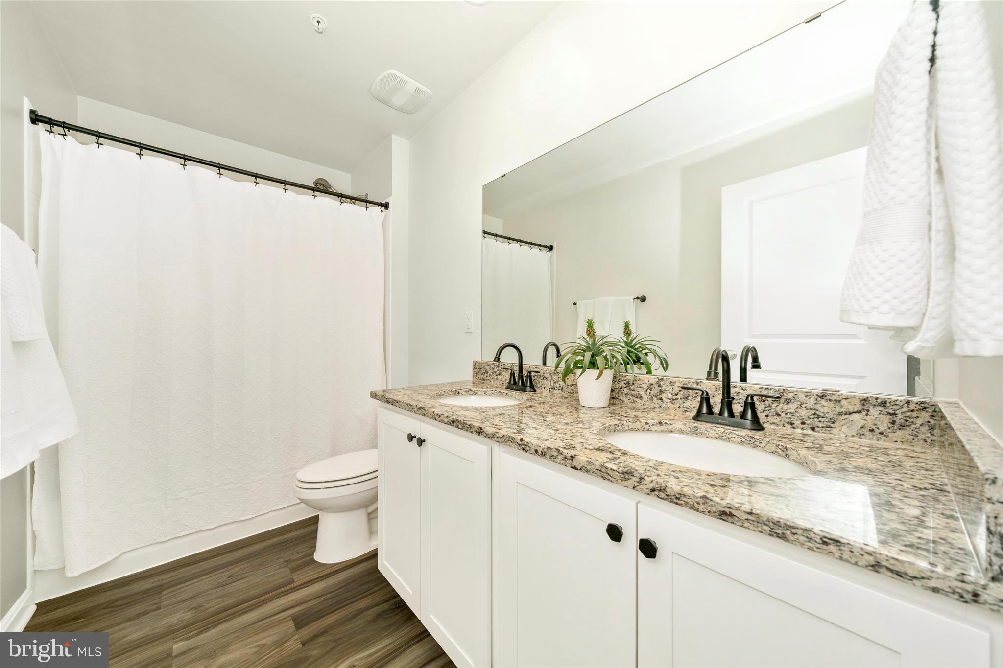 2086 Pomona Way Frederick, MD 21702 - Photo 28 of 77 a bathroom with a granite countertop sink and a mirror