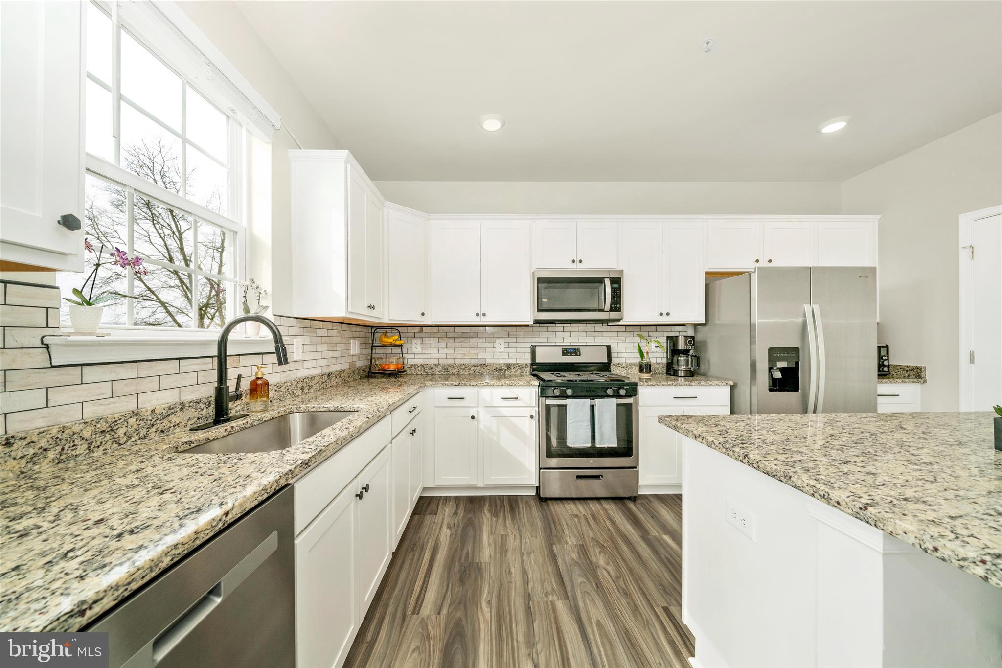2086 Pomona Way Frederick, MD 21702 - Photo 8 of 77 a large kitchen with stainless steel appliances granite countertop a lot of counter space and wooden floors