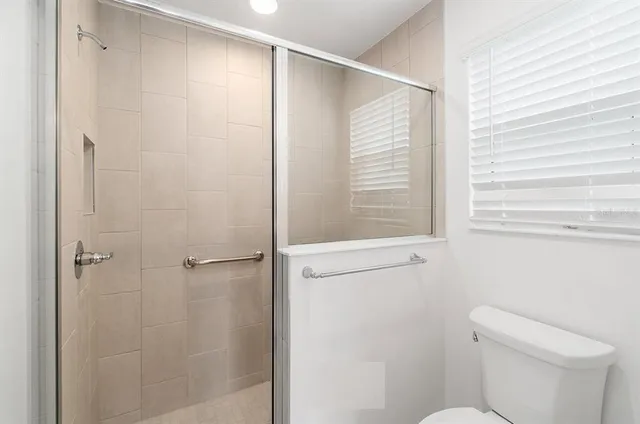 a bathroom with a shower and a toilet
