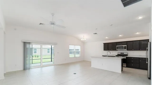a view of kitchen with windows and cabinets