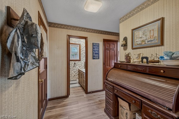 8675 West Smith Road Medina, OH 44256 - Photo 7 of 25 Hallway with wood-finish flooring, patterned wallpaper with a decorative border, and solid wood interior doors