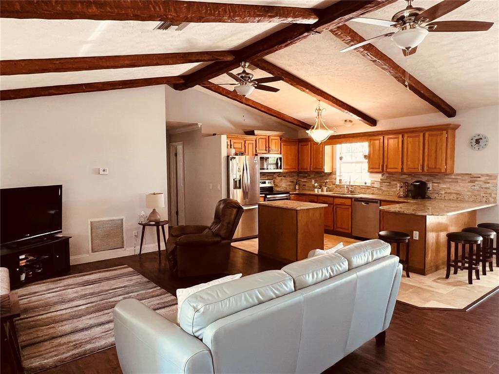 7961 West Riverbend Road Crystal River, FL 34428 - Photo 14 of 40 a living room with furniture and kitchen view