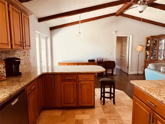 a kitchen with stainless steel appliances granite countertop a stove and wooden floors