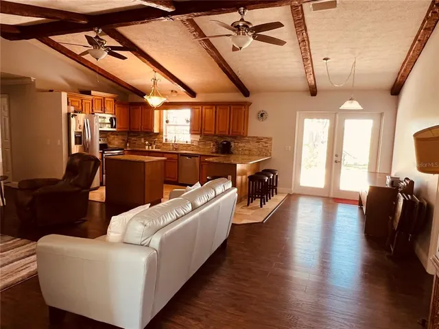 a kitchen with stainless steel appliances granite countertop a stove a sink a microwave and a refrigerator