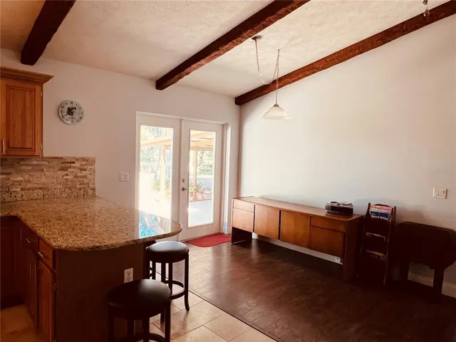 a kitchen with a sink a counter top space and living room