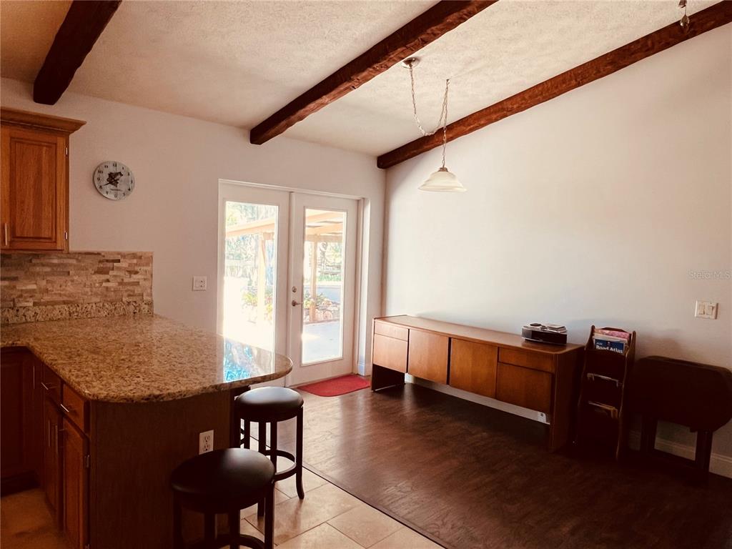 7961 West Riverbend Road Crystal River, FL 34428 - Photo 21 of 40 a view of a dining room with furniture window and wooden floor