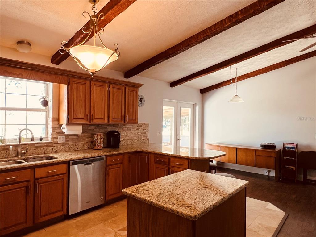 7961 West Riverbend Road Crystal River, FL 34428 - Photo 22 of 40 a kitchen with a sink a counter top space and living room