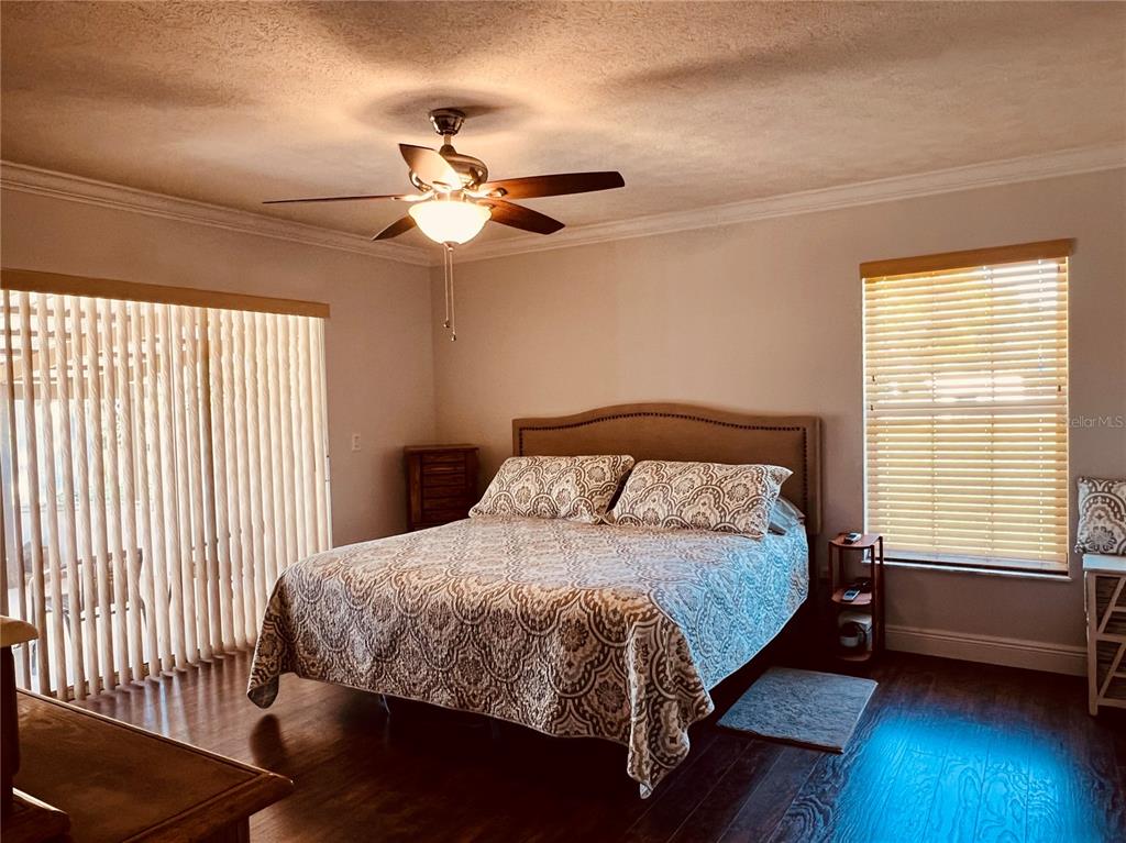 7961 West Riverbend Road Crystal River, FL 34428 - Photo 24 of 40 a bedroom with a bed a chandelier and a window