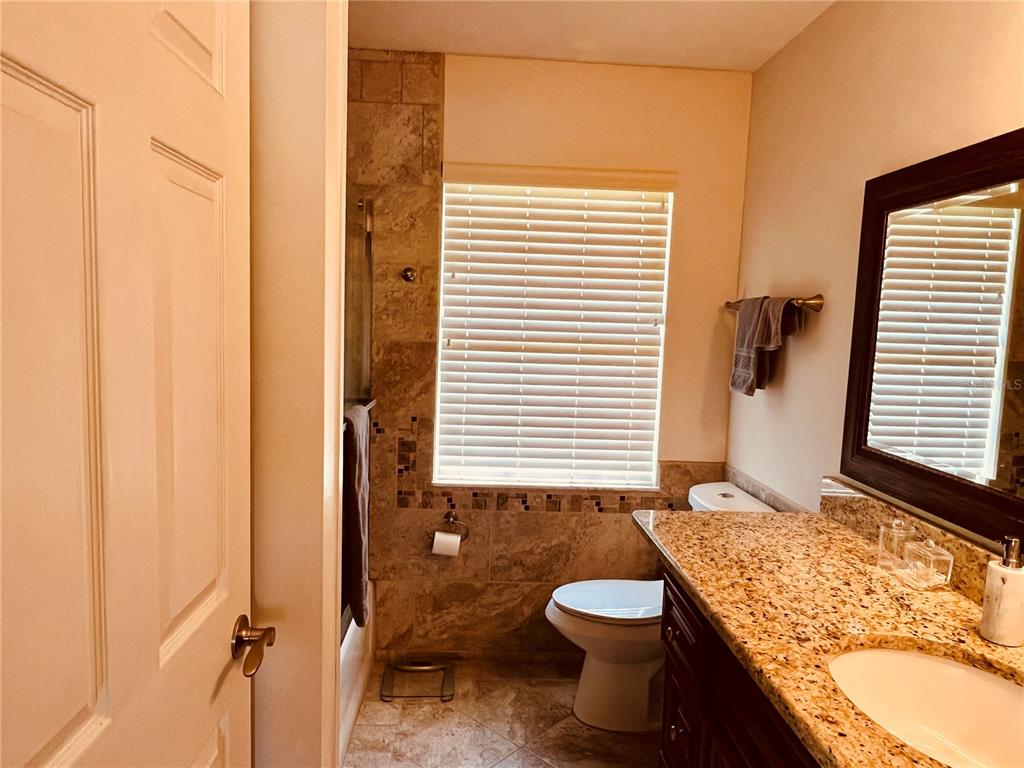 7961 West Riverbend Road Crystal River, FL 34428 - Photo 25 of 40 a bathroom with a granite countertop sink toilet and shower