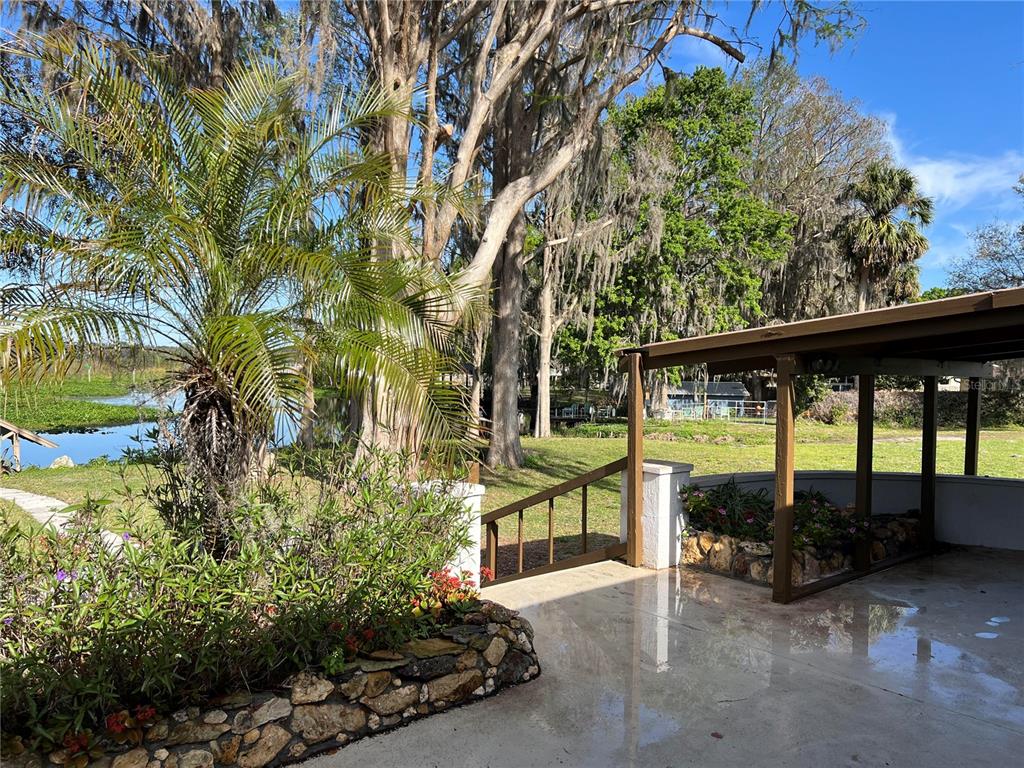 7961 West Riverbend Road Crystal River, FL 34428 - Photo 34 of 40 a view of a patio with table and chairs and potted plants
