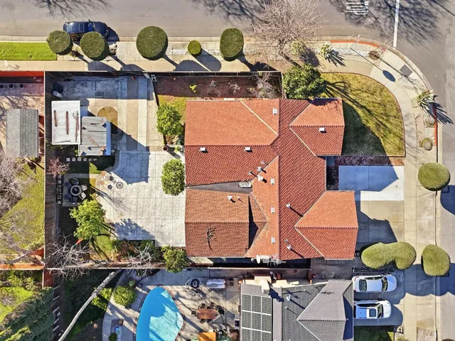 an aerial view of residential house with outdoor space and seating area