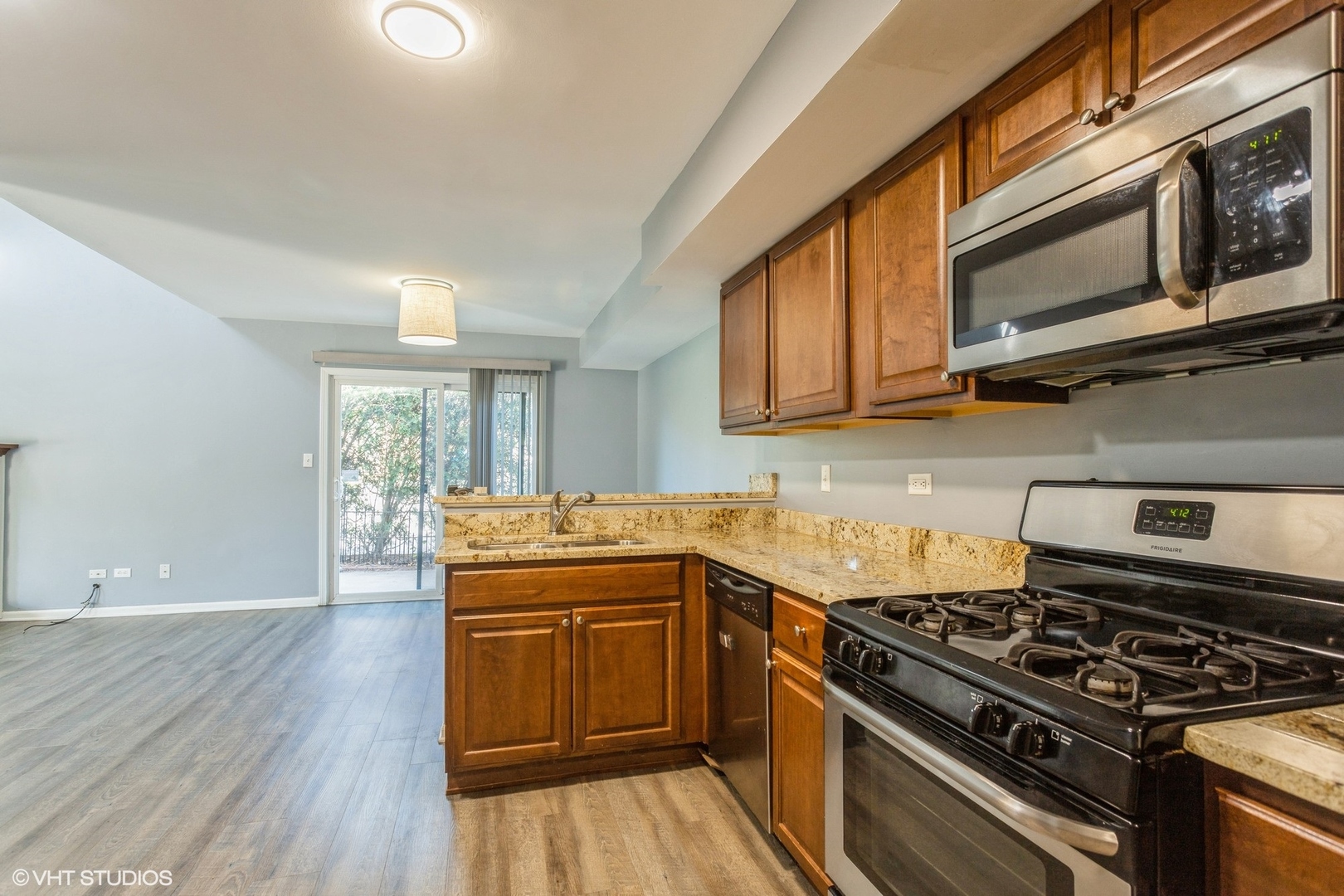 3022 Anton Drive Aurora, IL 60504 - Photo 6 of 15 a kitchen with stainless steel appliances granite countertop a stove and a sink