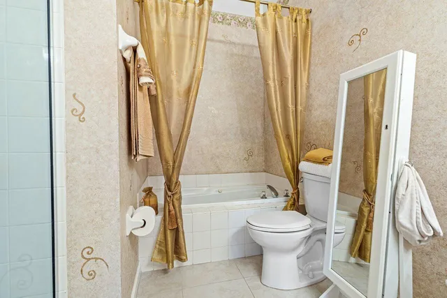 a bathroom with a toilet and a shower
