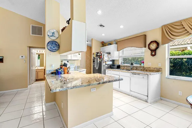 a kitchen with stainless steel appliances granite countertop a sink and a cabinets