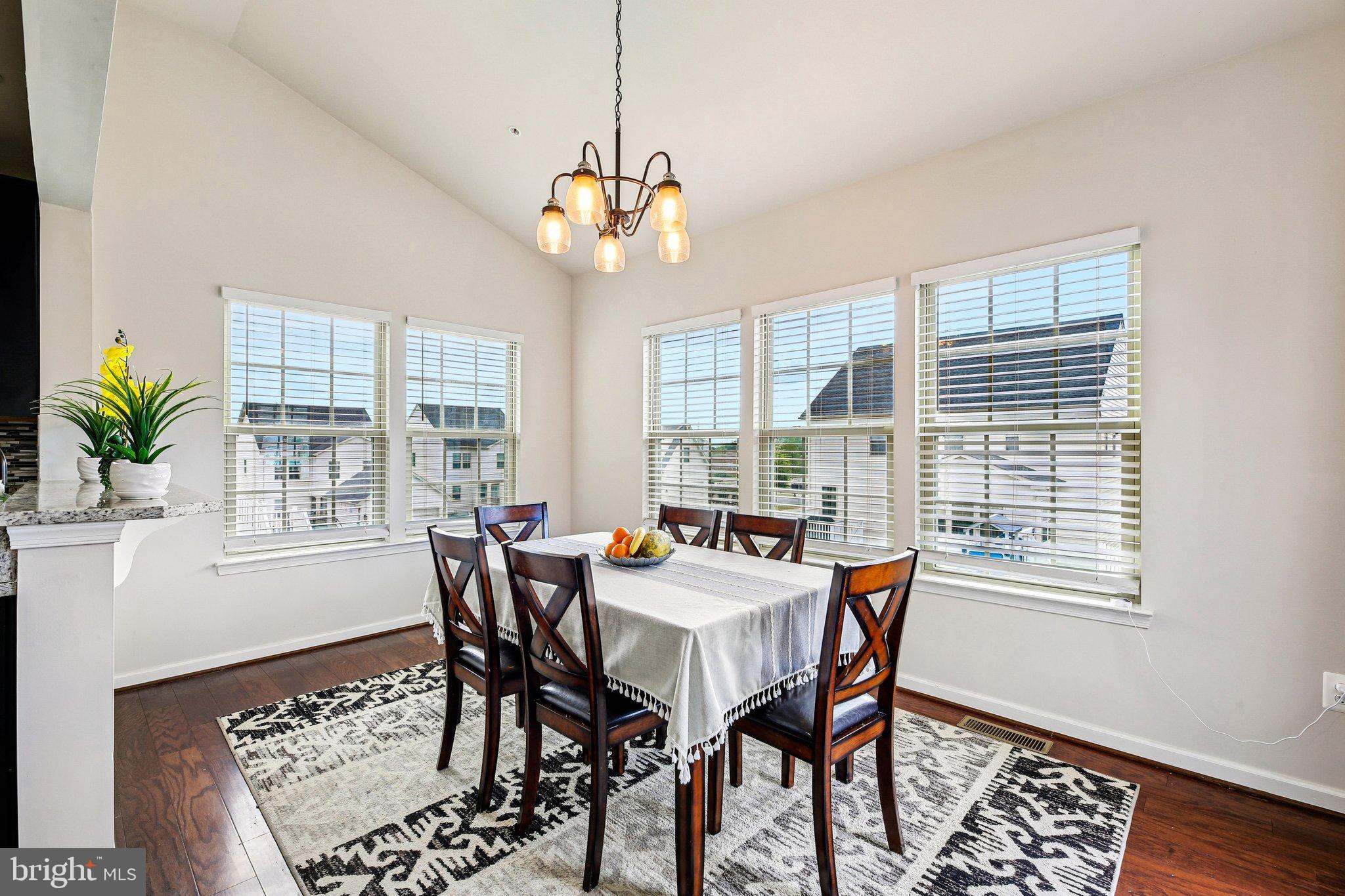 5940 Duvel Street Ijamsville, MD 21754 - Photo 13 of 62 a dining room with wooden floor a chandelier a wooden table and chairs
