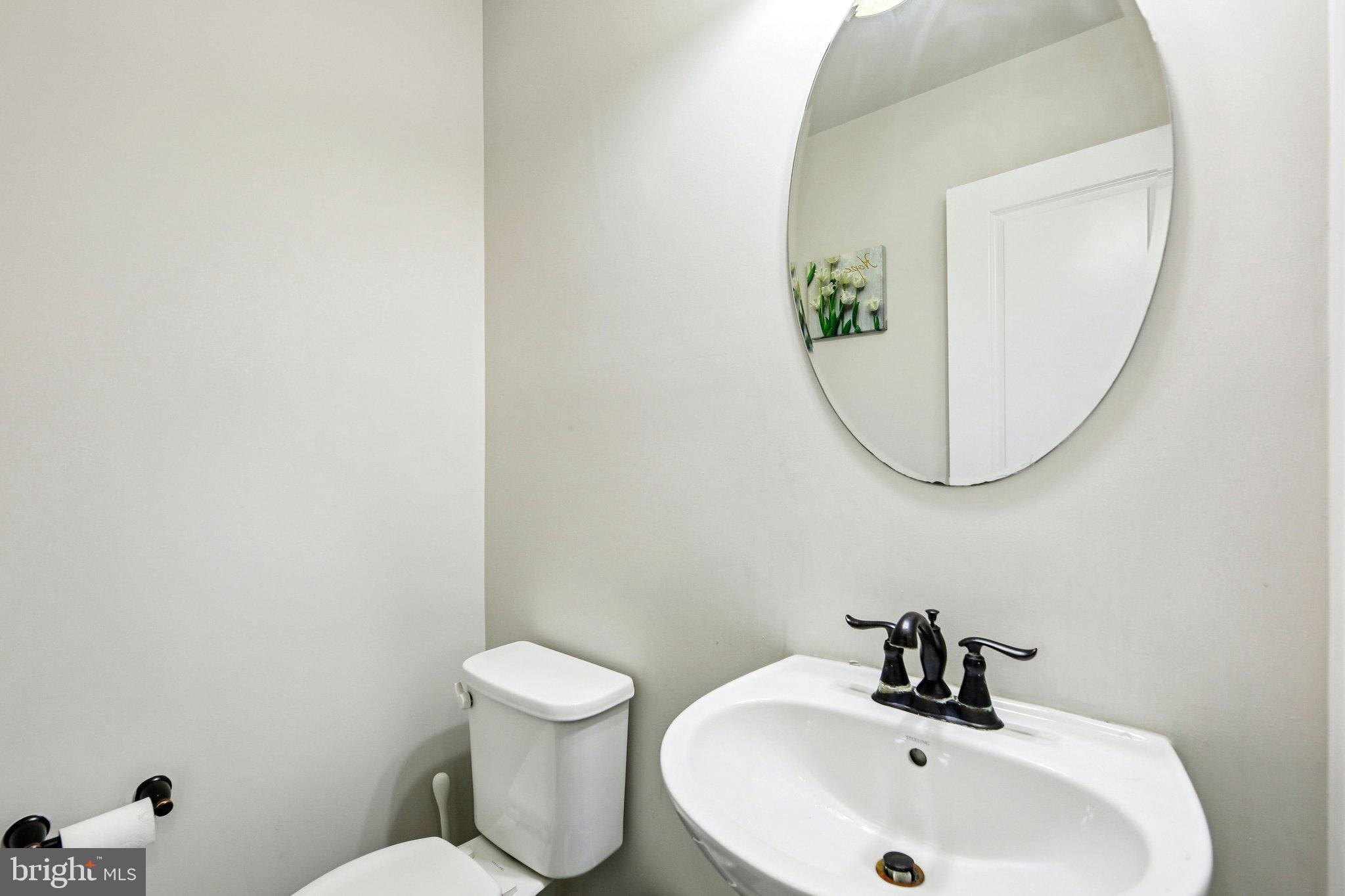 5940 Duvel Street Ijamsville, MD 21754 - Photo 21 of 62 a bathroom with a sink and a mirror