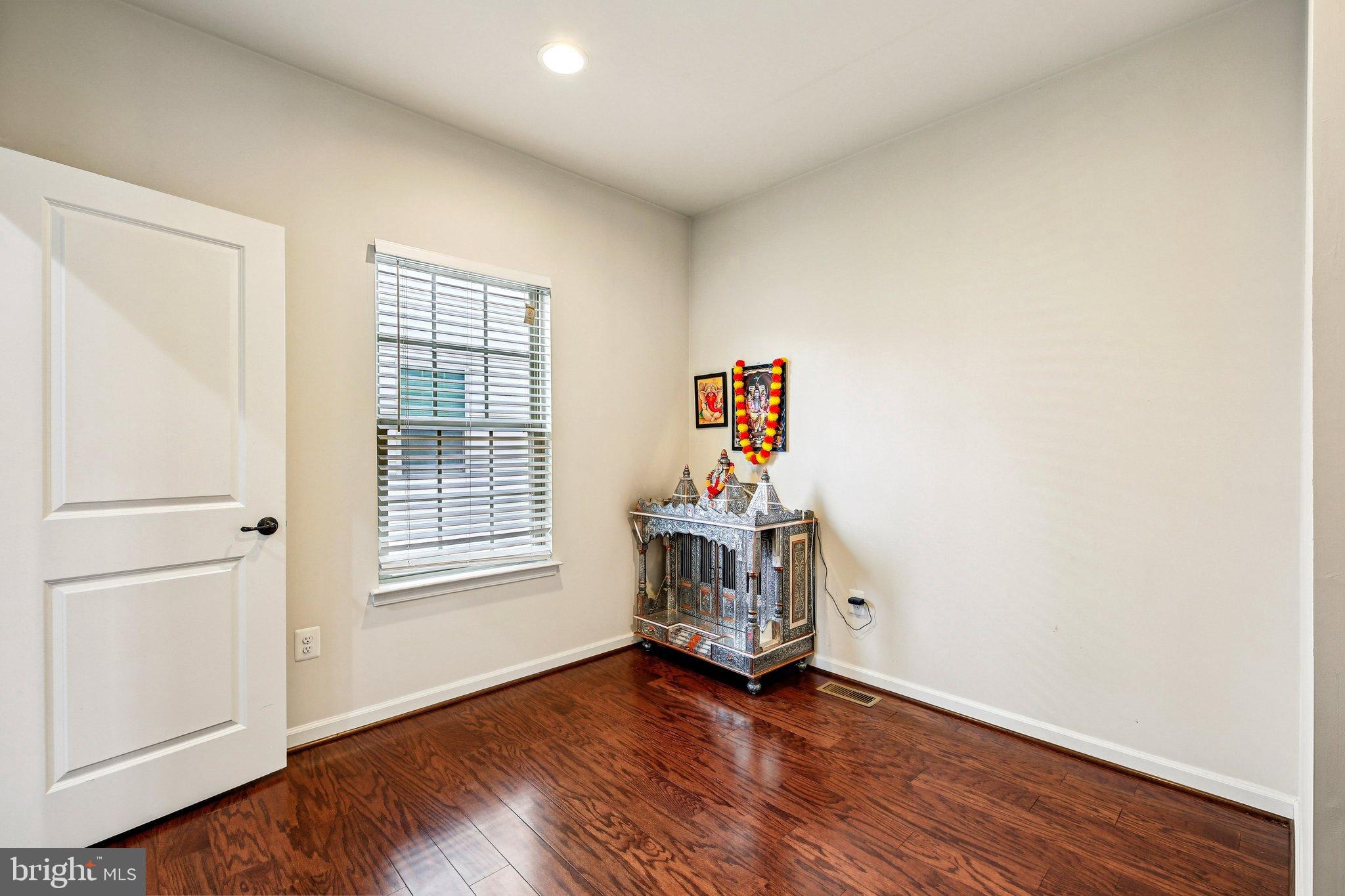 5940 Duvel Street Ijamsville, MD 21754 - Photo 23 of 62 a view of an empty room with a window and wooden floor