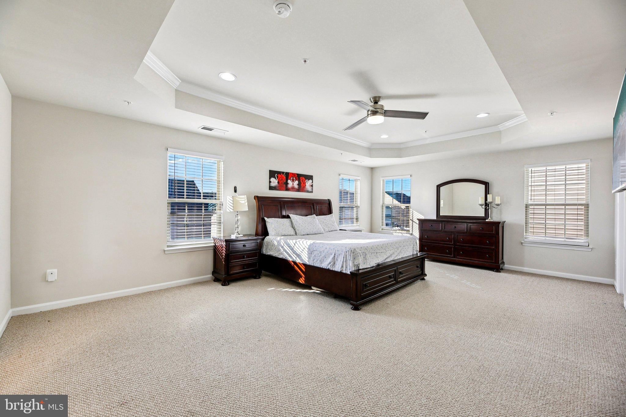 5940 Duvel Street Ijamsville, MD 21754 - Photo 34 of 62 a bedroom with a bed a ceiling fan and a couch