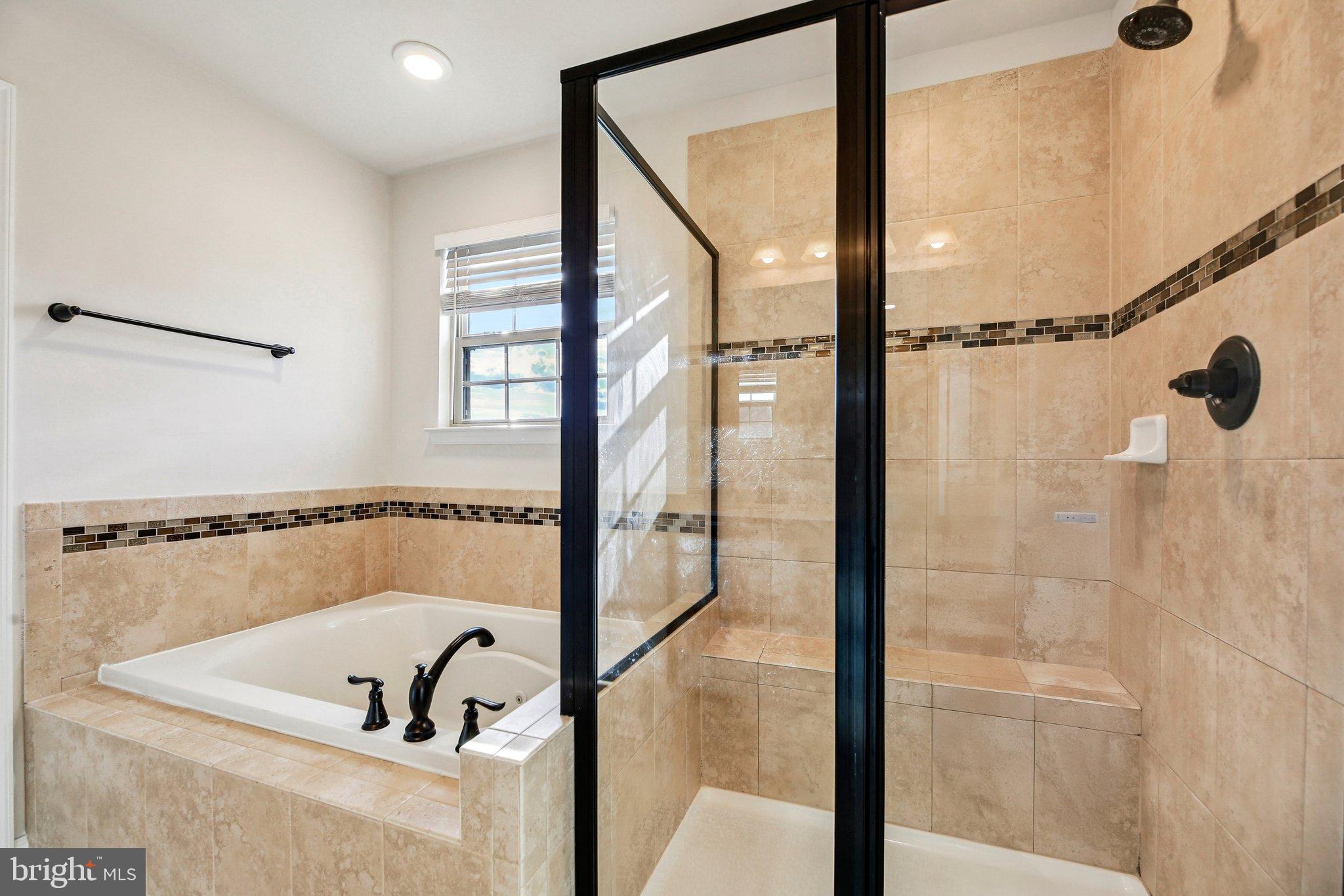 5940 Duvel Street Ijamsville, MD 21754 - Photo 37 of 62 a bathroom with a shower and a tub