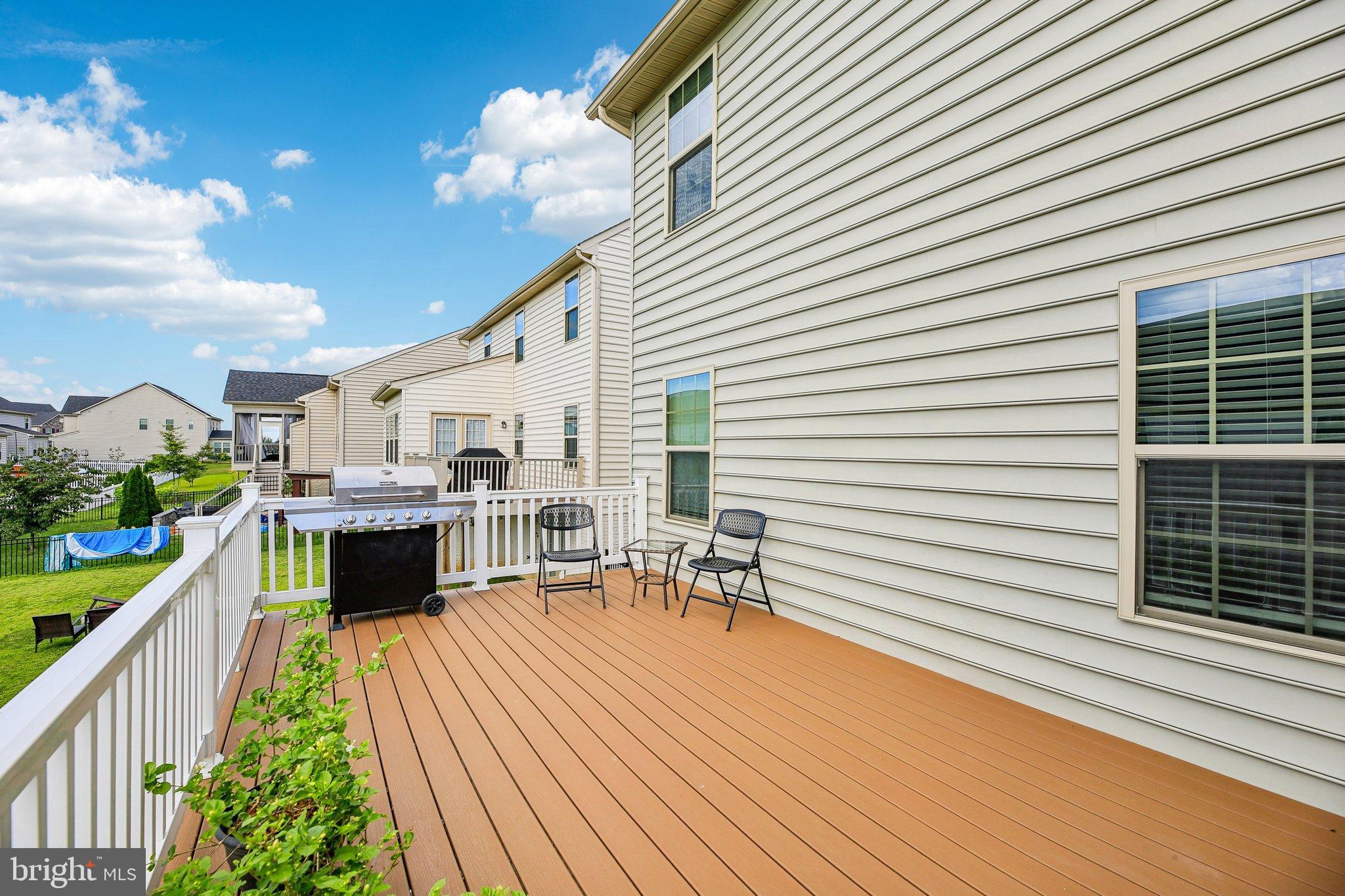 5940 Duvel Street Ijamsville, MD 21754 - Photo 49 of 62 a view of a patio with a dining table and chairs with wooden floor