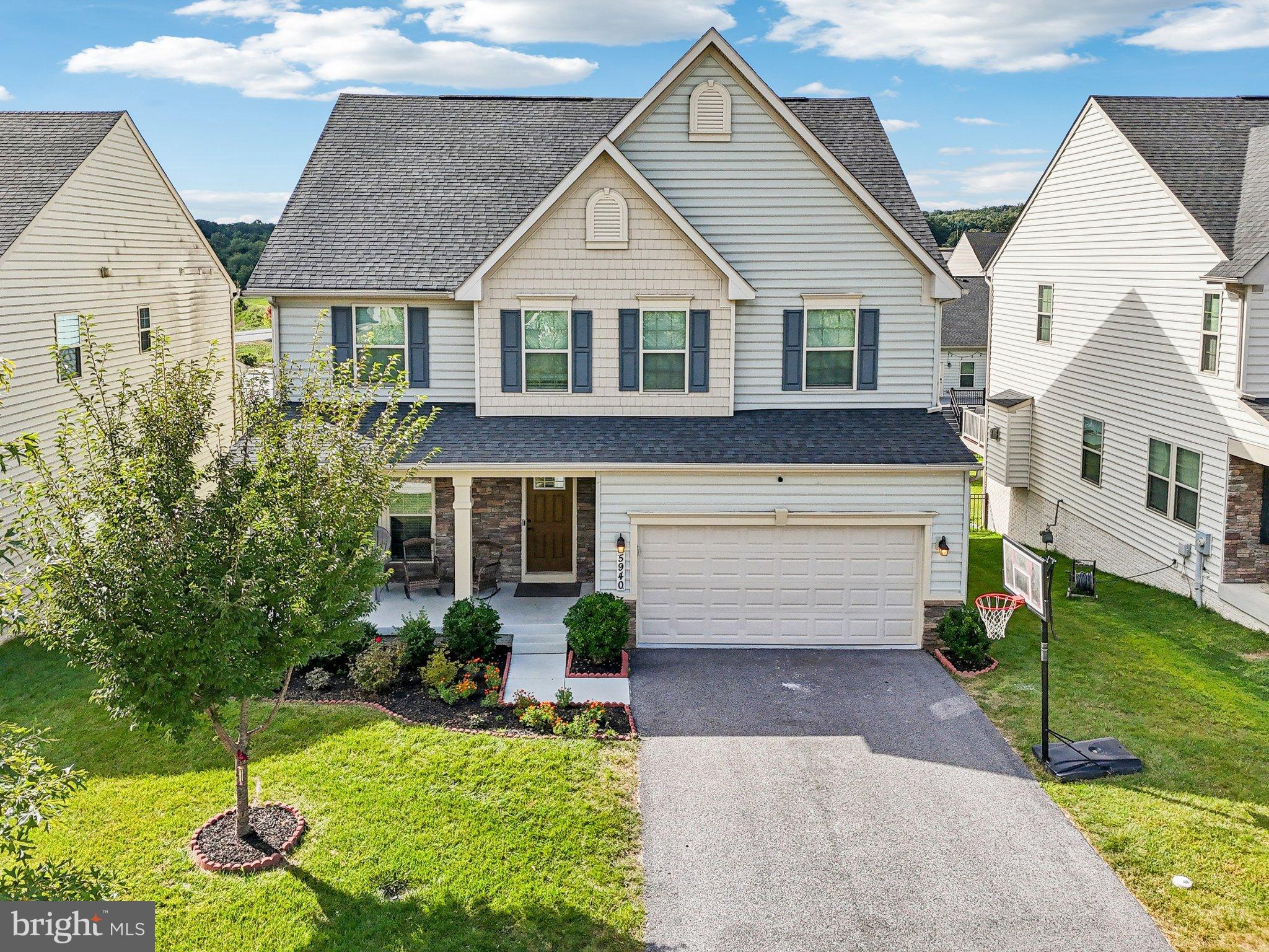 5940 Duvel Street Ijamsville, MD 21754 - Photo 51 of 62 a front view of a house with a yard and garage