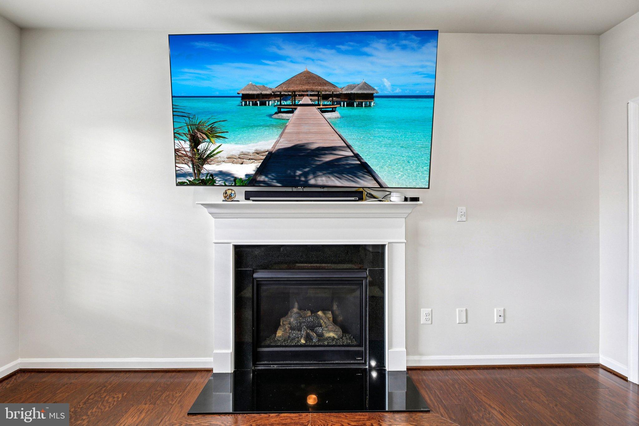 5940 Duvel Street Ijamsville, MD 21754 - Photo 9 of 62 a living room with a fireplace and a wooden floor
