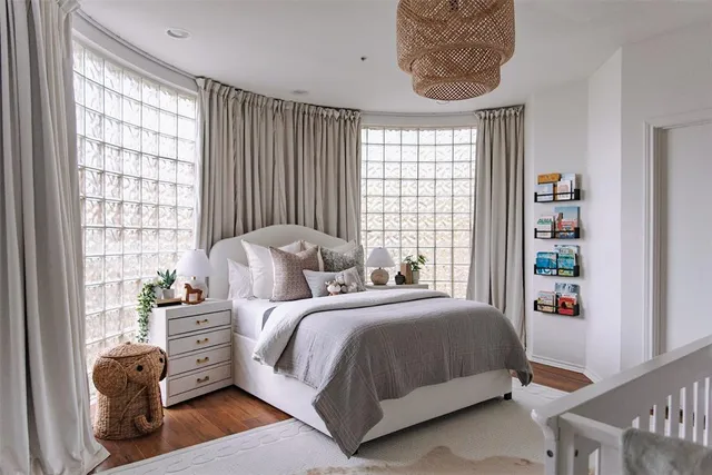 a bedroom with bed and a large window